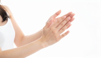 Woman in white shirt holding hands image of woman wearing white shirt gently holding own hands conveying calm and introspection