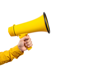 A person's hand firmly gripping a bright yellow megaphone against a contrasting black backdrop