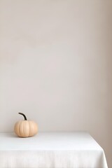 Beige Pumpkin on White Table with Soft Minimal Background