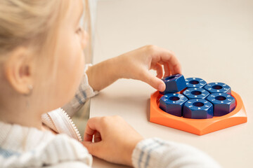 girl solving logic puzzle, Children hands playing with educational math STEM game using pieces learning number composition seven practicing logic thinking fun cognitive activity and math skills
