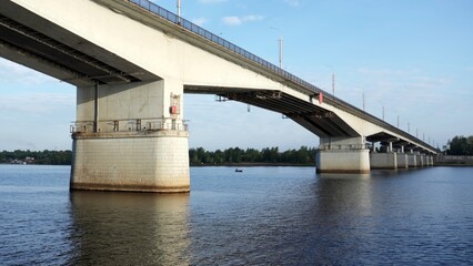 Concrete road bridge spanning a wide river. Clip