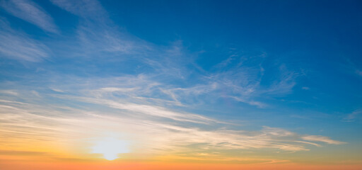 Obraz premium Sundown cloudscape. Fluffy clouds in the sunset of dark blue - pink - orange sky. Dreamy evening. Beautiful daybreak