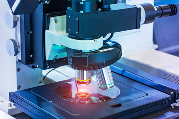 Silicon Wafers with microchips used in electronics for the fabrication of integrated circuits under the microscope