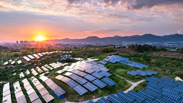 Aerial views of solar farms with mountains in the distance - Powered by Adobe