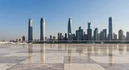 Obraz premium Modern city skyline with tall skyscrapers reflecting on empty marble plaza under clear blue sky during bright daylight