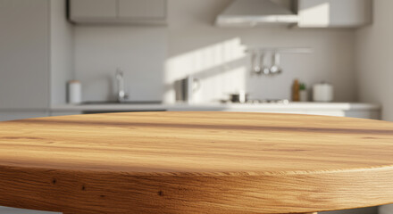 Round natural wooden table surface in modern minimalist kitchen with sunlight streaming across contemporary appliances