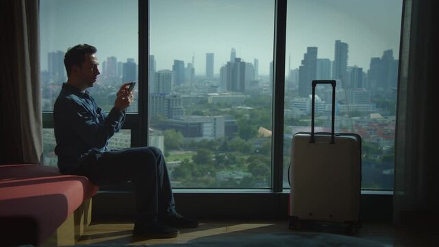 A business traveler enjoying a hotel room that offers a stunning view of the cityscape