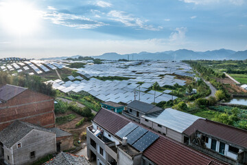 Aerial views of solar farms with mountains in the distance