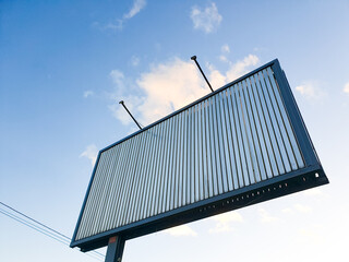 Commercial billboard with empty space for advertising on the city skyline. Metal advertising shield, advertising space, industrial city billboard.