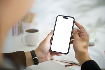Close up of hands holding smartphone with blank white screen for mockup design.