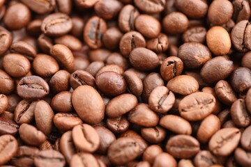 Coffee texture roasted beans from above soft light close up