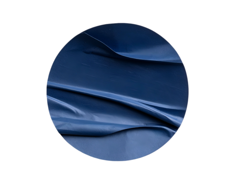A navy blue fabric piece, gently draped within a circular frame, showcasing texture and shadows