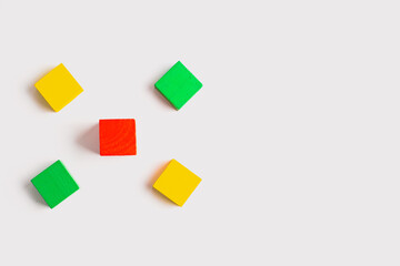 Four Colorful Wooden Blocks and One Red Block Centered