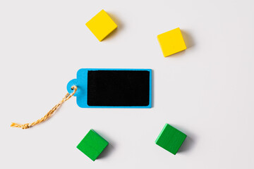Minimal Tag and Colorful Wooden Blocks on White Background