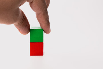 Hand Touching Stacked Wooden Blocks on White Background