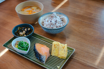 Traditional Japanese breakfast with grilled salmon and miso soup
