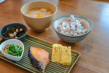 Traditional Japanese breakfast with grilled salmon and miso soup
