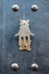 Morocco, wooden door with a knocker in the shape of the Hand of Fatima (Hamsa or Khamsa), ancient...