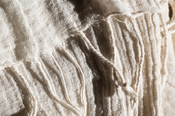 Close-up of soft, light-colored mesh fabric. The texture is visible, showcasing its delicate weave and airy quality.