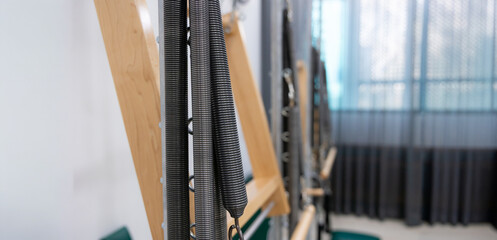 Background and banner. Pilates exercise machine at gym. Wooden pilates machine. Wooden Fitness...