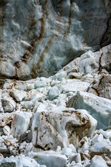 Shkhara Glacier Terminus In The Caucasus Mountains Near Ushguli Georgia: Dramatic View Of Ice Wall, Moraine And Rocky Foreground