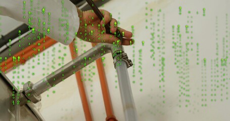 Technician's hand tightening hose clamp on pipe in utility room, with binary code, orange conduit