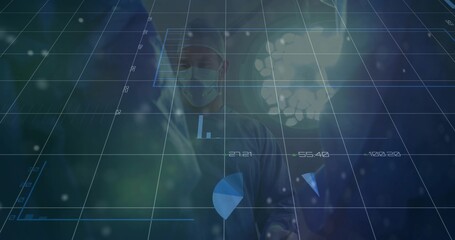 Naklejka premium Standing surgeon wearing surgical attire monitoring digital overlay in OR under surgical light