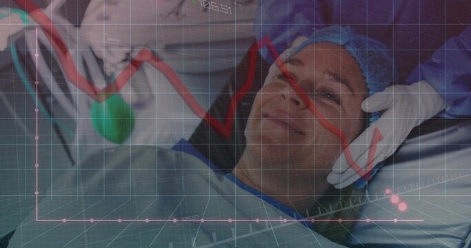 Reclining gowned, capped patient receiving gloved support from doctor on table in OR, graph overlay