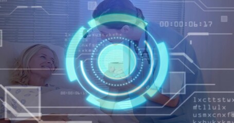 Leaning nurse in scrubs holding gowned patient hand at hospital bedside with tablet hologram