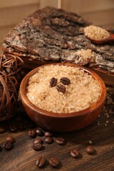 Natural sea salt and coffee beans on wooden table, closeup