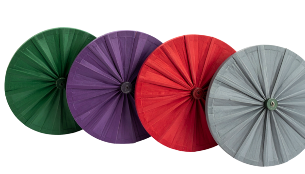 Four colorful, circular objects resembling folded paper or fabric fans on a black background