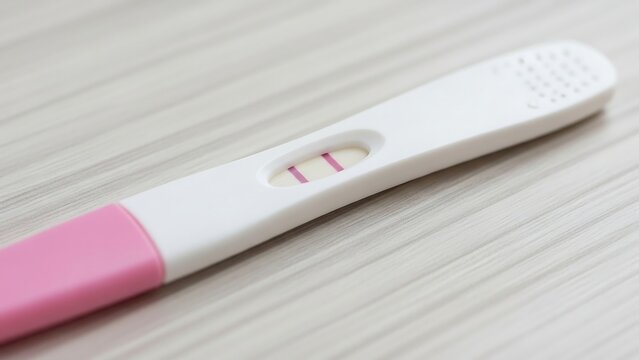 Macro Shot of Pregnancy Test Strip Showing Faint Colored Line on Wooden Bathroom Counter