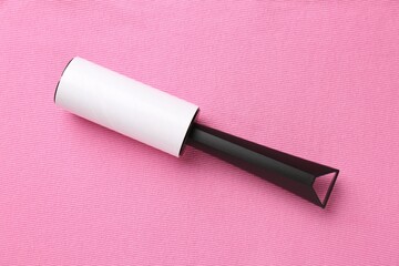 Sticky lint roller on pink shirt, top view