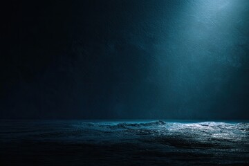 Dramatic dark blue ocean scene with waves illuminated by a single light source