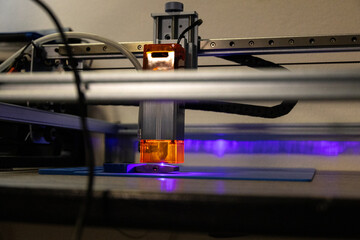 Close-up of automated CNC laser cutting equipment in action, showcasing advanced machinery and...
