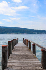 Fototapeta premium Wooden pier overlooking the Alps and Lake Constance in Switzerland