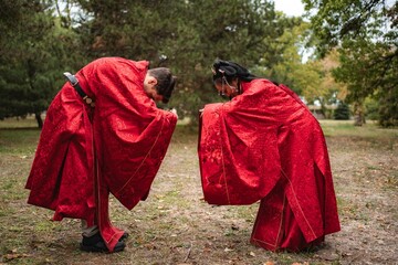 Multicultural wedding couple bowing in traditional Chinese ceremony