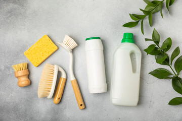 Eco cleaning.Cleaning products on a textured background. Eco-friendly home cleaning. A bottle of natural detergent surfaces, eco brushes, sponges, and rags. Cleaner concept.Cleaning supplies.Flat lay.