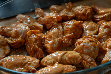 Raw chicken wings in spicy marinade, preparation for cooking, homemade food and kitchen concept