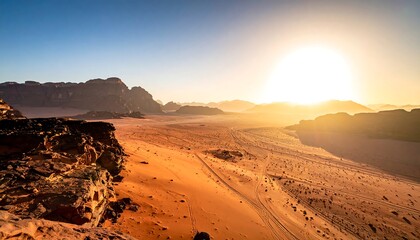 Golden desert landscape with the sun rising over distant rock formations