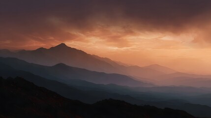 Naklejka premium Dramatic mountain range at dusk under a fiery orange and purple sky
