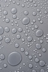 Water drops on abstract gray background. Macro photo. Top view.