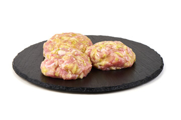 Raw Meatballs on Black Slate, isolated on white background