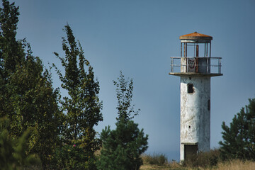 Weathered Neeme Lighthouse on Estonia's Coast, Standing Tall Against the Blue Sky