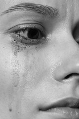 Fototapeta premium Closeup view of sad young woman crying. Black and white effect