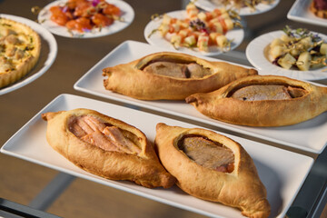 A Display of Delicious and Savory Pastries Beautifully Arranged on a Buffet Table for All