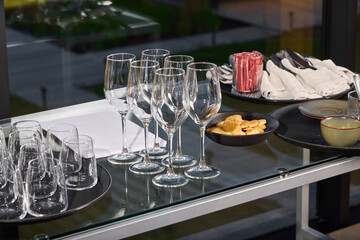 An Elegant Dining Setup Featuring Exquisite Glassware Alongside Delicious Snacks for Enjoyment