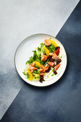 A colorful salad of shrimp, arugula and sun-dried tomatoes. Italian cuisine. Top view.