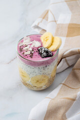 Chia pudding in a glass with berries and fruits. A light, quick breakfast, vegetarian, and healthy.