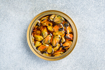 Canned mussels in a metal jar. Canned food in aluminum cans.